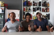 Ex, Lwand and Brian behind the bar at Skhulu's Lounge in KwaNokuthula, Plettenberg Bay