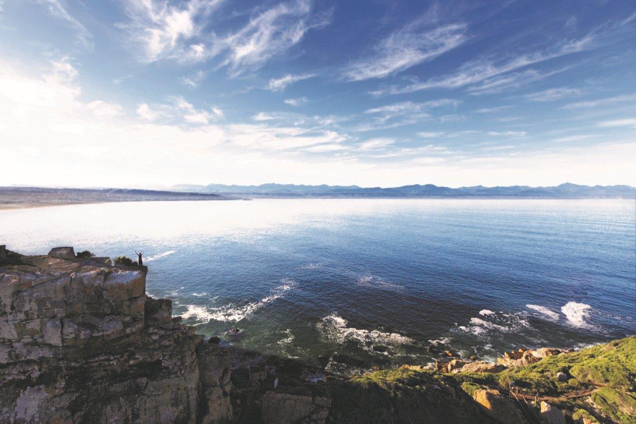 Plett Adventure, showcasing different adventure activities from the area. This image is a hiker on Robberg Nature Reserve, one of Plett’s most iconic landmarks and activities.
